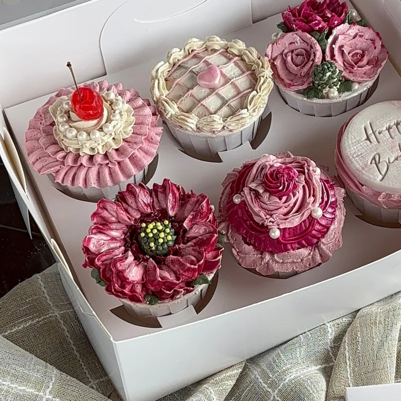 Gift box of six vintage-style cupcakes with ruffles, a lattice, piped roses and a cherry