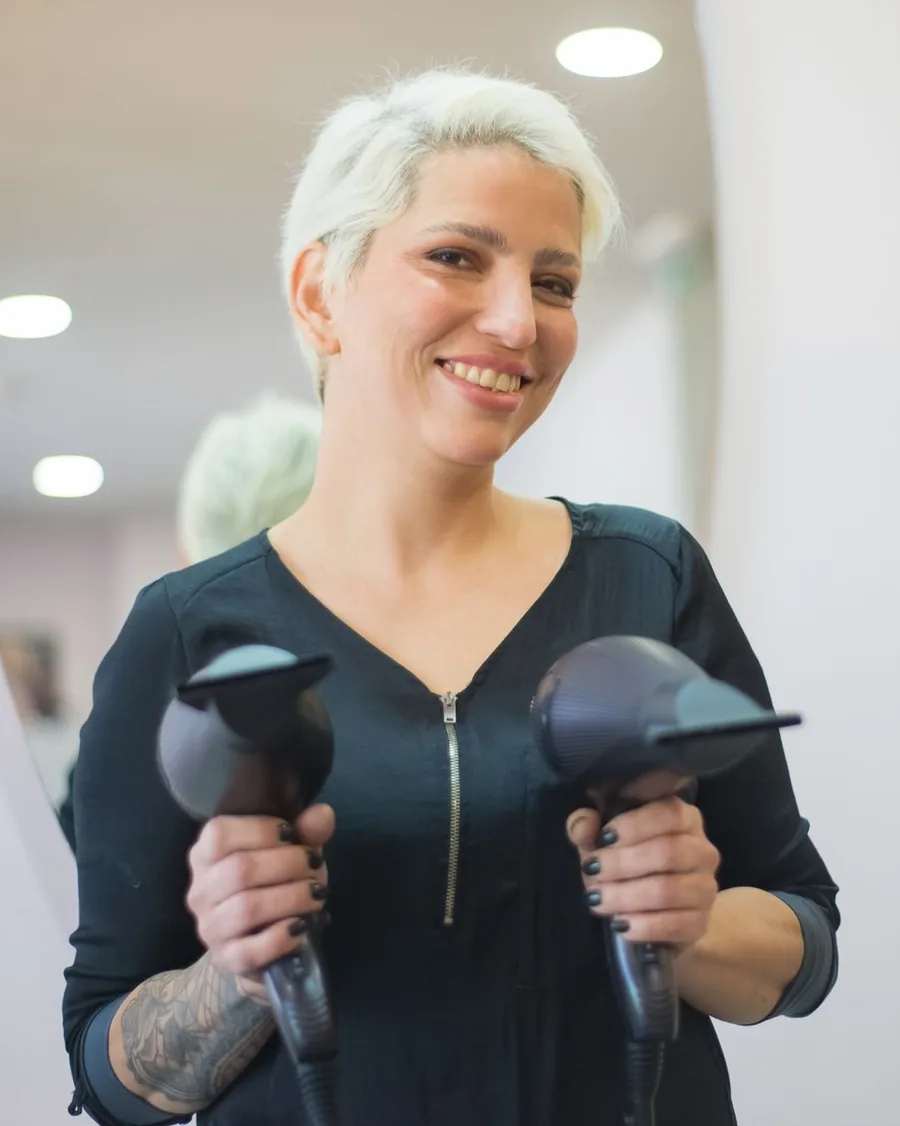 Nora, stylist and co-owner of Sundrift, holding two hair dryers