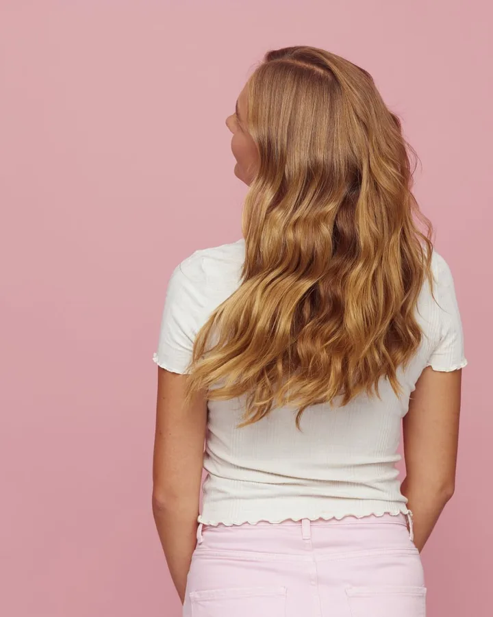 Long golden-beige waves seen from behind