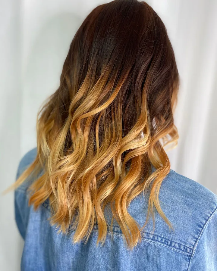 Dark roots melting into golden ends