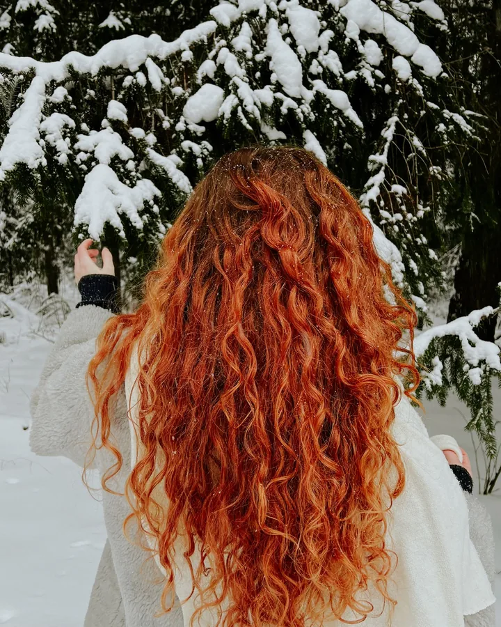 Long copper curls against a snowy background