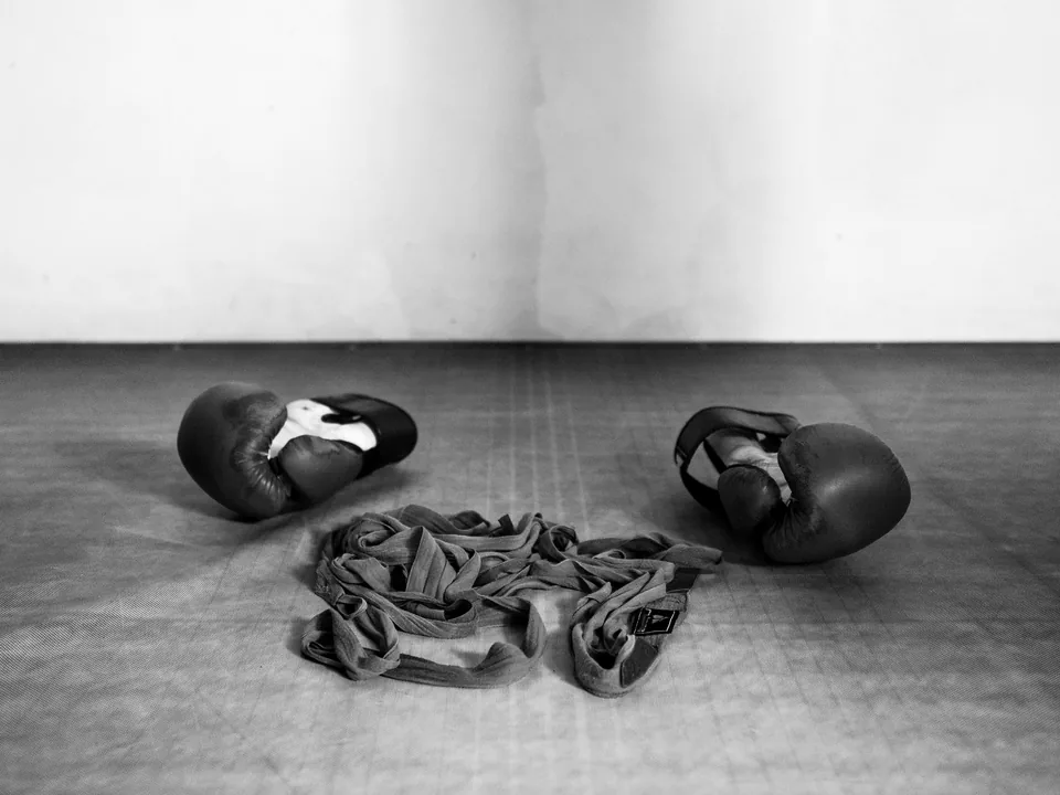 Gloves and hand wraps laid out on the mat