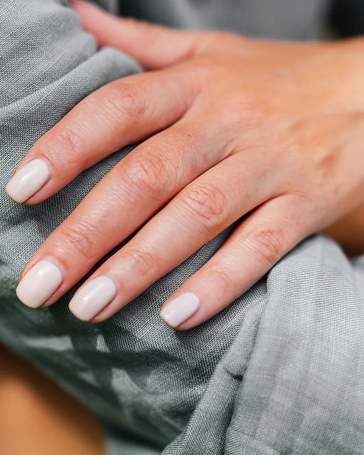 Natural nails grown longer under a milky BIAB overlay
