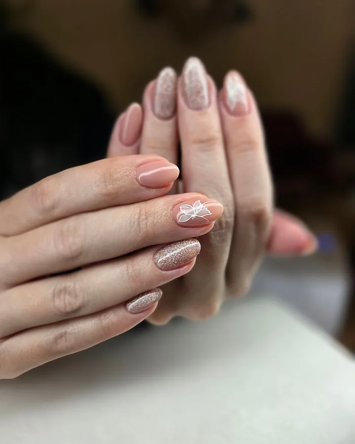 Almond nude nails with glitter fades and one fine white line design