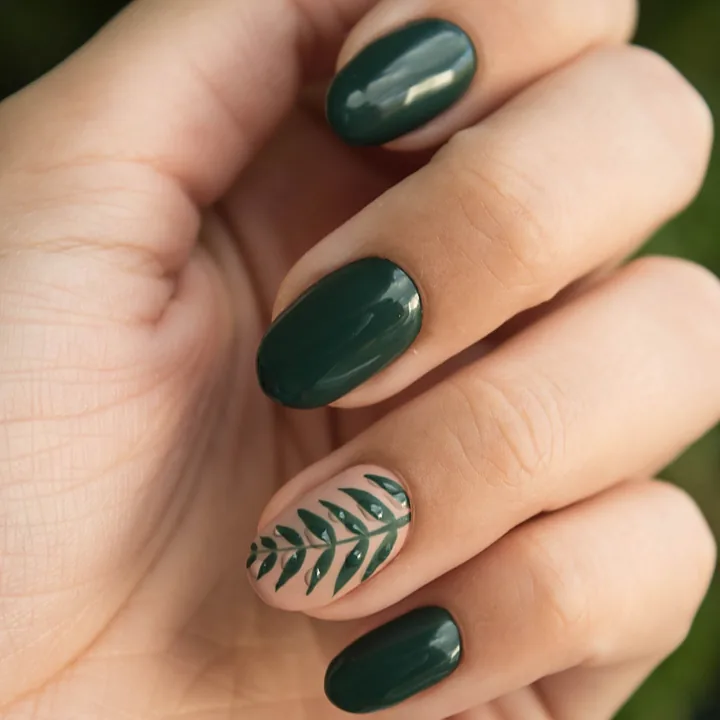 Deep green gel nails with one hand-painted fern accent nail