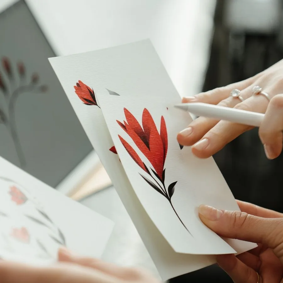 Red line flash: a single red lily on a card