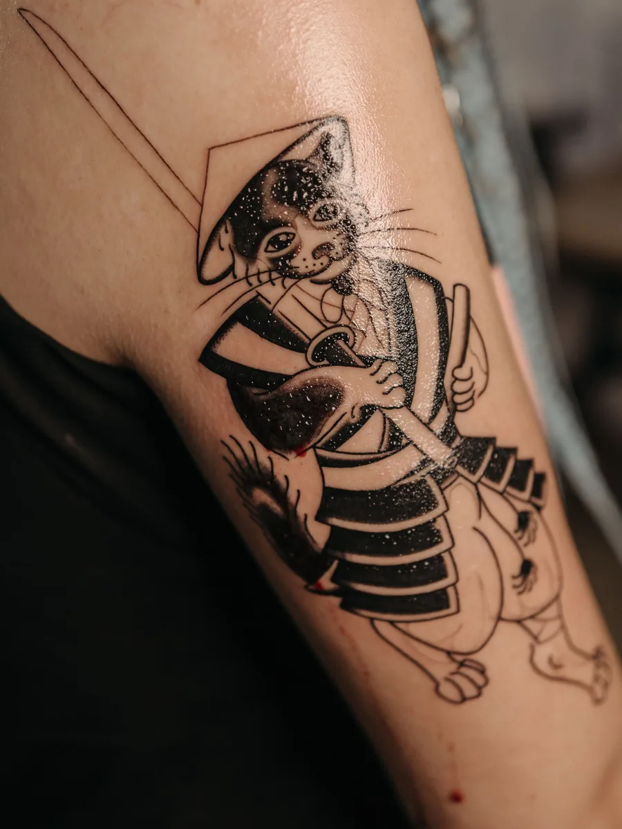 Blackwork samurai cat on a forearm by Hank