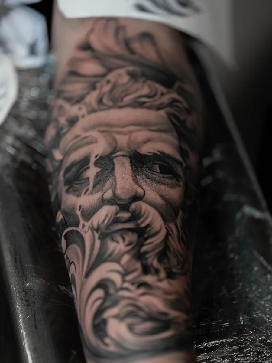 Black and grey realism portrait on a forearm by Tomas