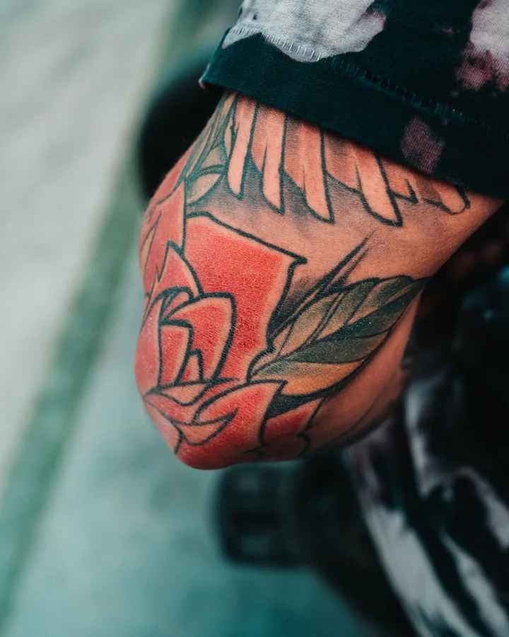 Bold traditional rose on an elbow by Dex