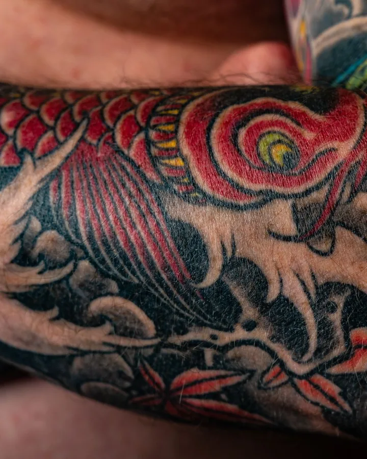 Japanese colour koi and waves on a forearm by Kai