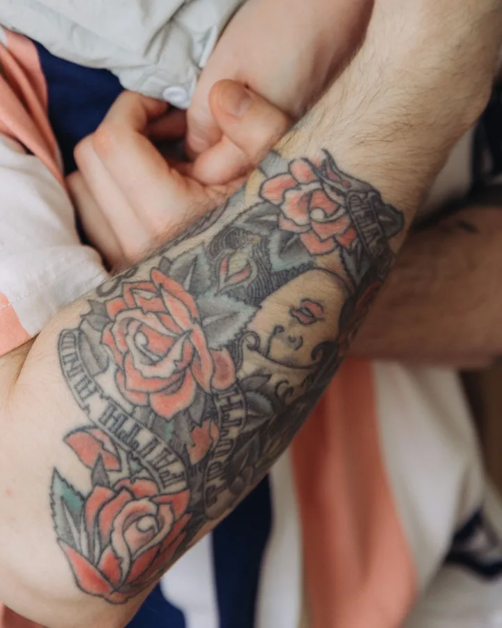 Neo-traditional roses on a forearm by Marisol
